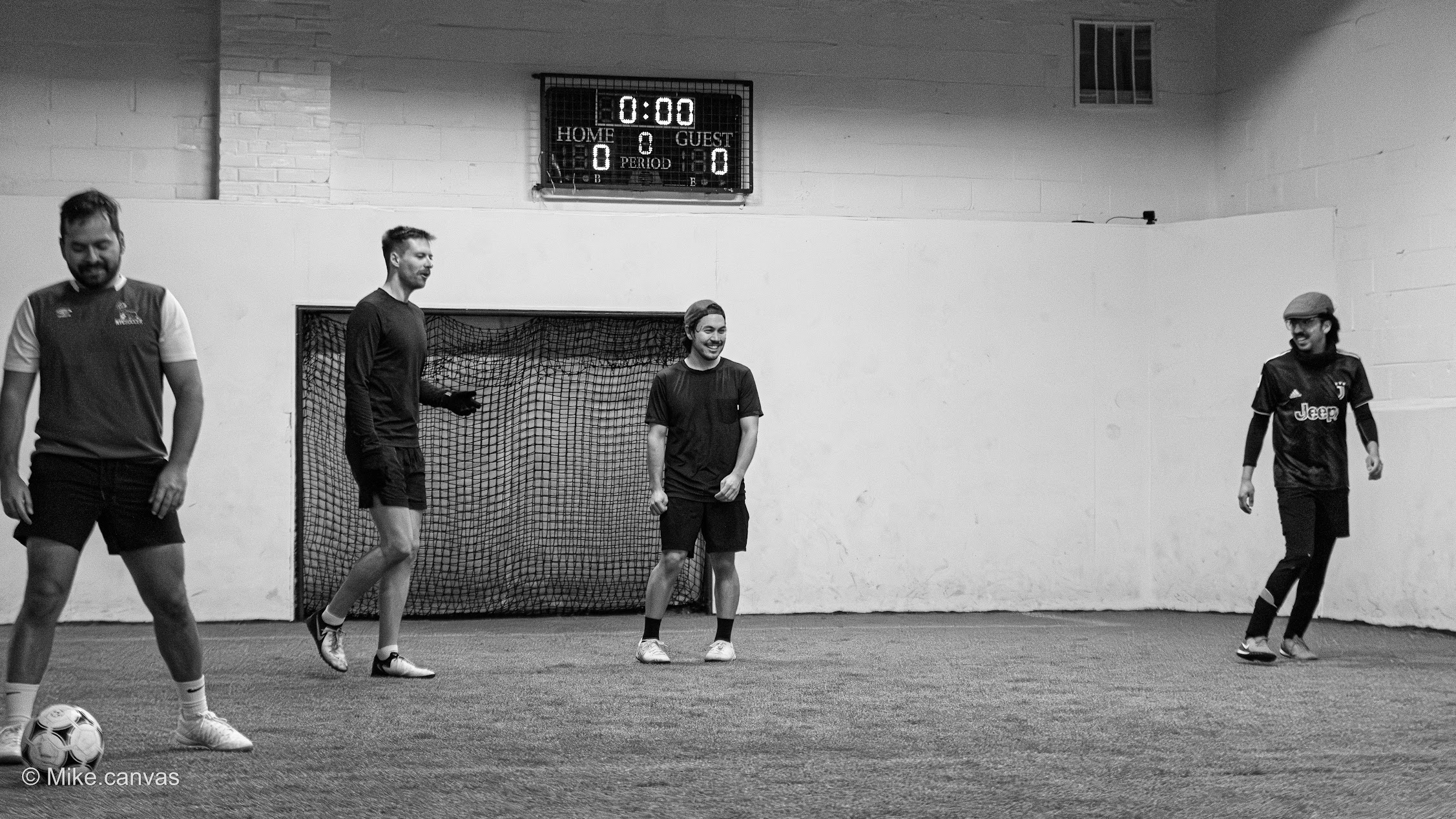 Players gathered at NextGoal pickup soccer match in action